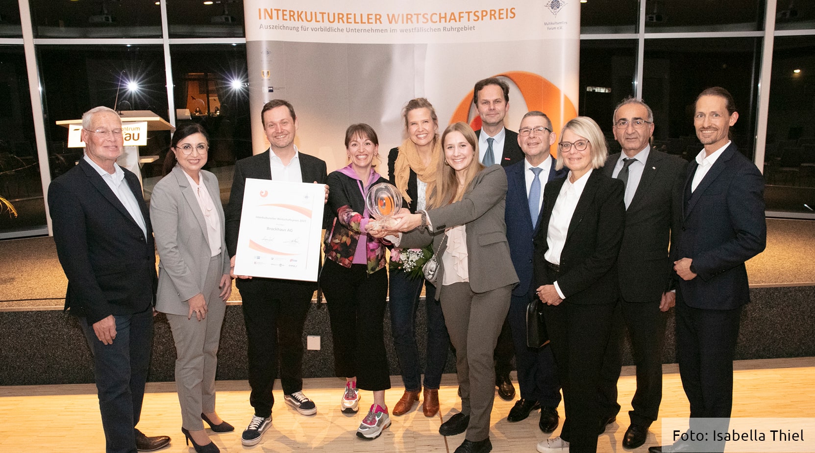 Die Preisträger posieren zusammen mit der Jury und ihrer Trophäe